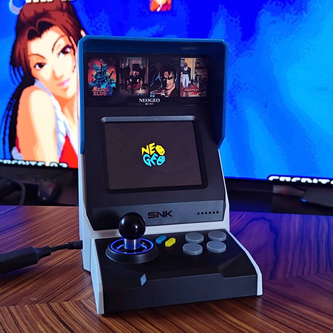 Neo Geo Mini arcade machine with Mai on screen in backdrop.