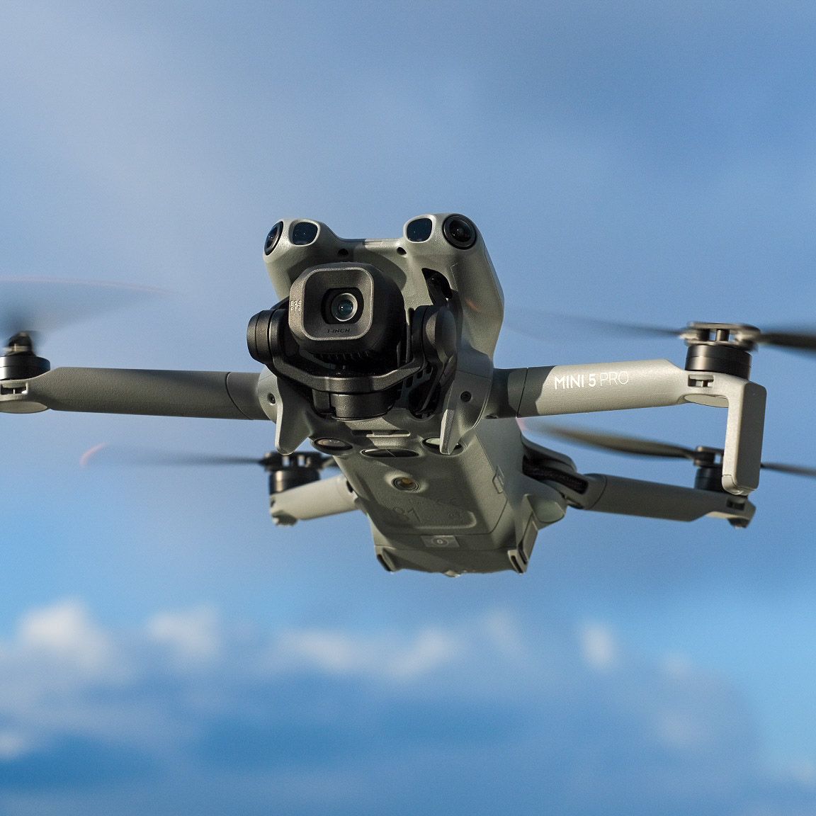 The DJI Mini 5 Pro drone, sleek and compact, showcasing its advanced camera and foldable design against a clean background, ready for aerial content creation.