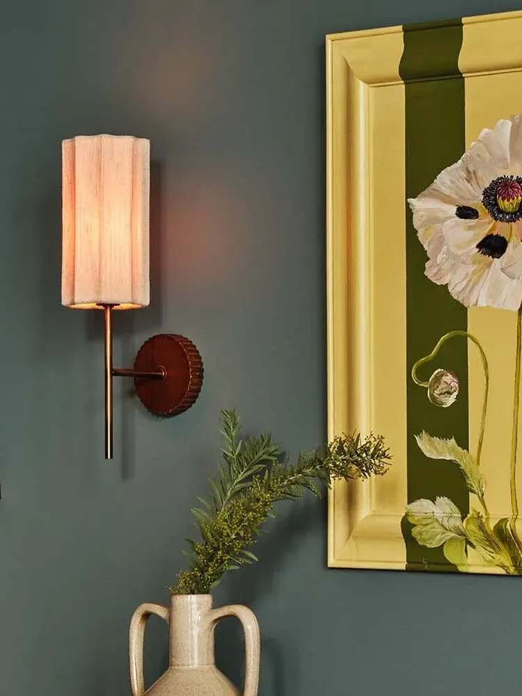 modern porcelain wall sconce in bedroom with plant