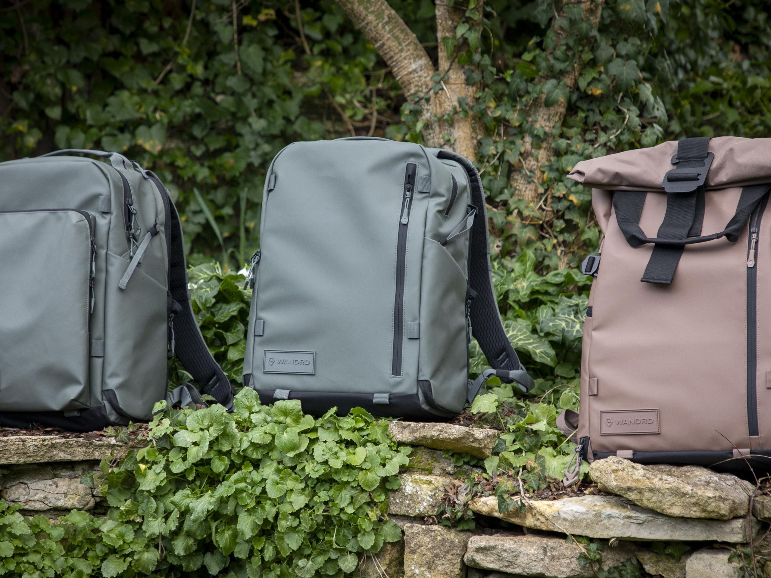 That trendy roll-top camera backpack has two new zip-up siblings