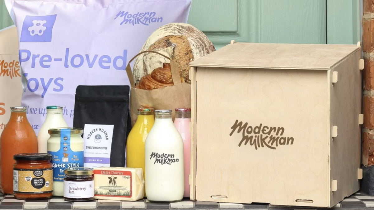 an image of a wooden modern milk box with different products on a chequered doorstep