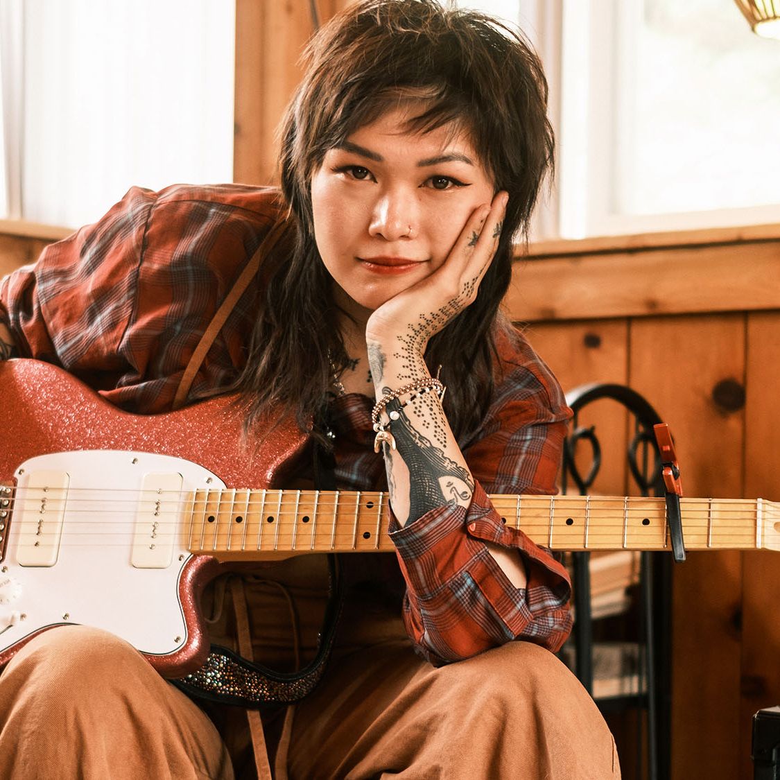 Yvette Young sits at home with her pink Ibanez Talman prototype with Wilkinson P-90 pickups.