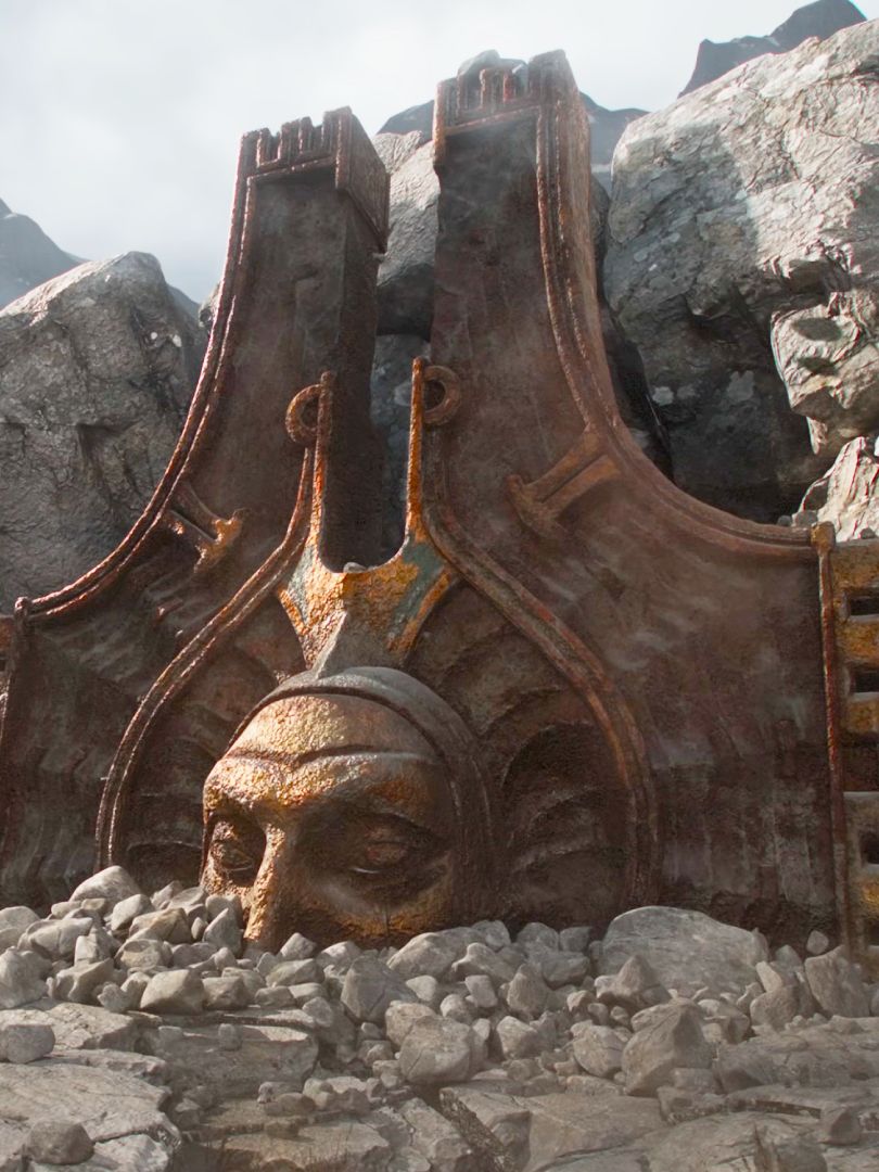 A screencap of the Path of Exile 2: Return of the Ancients teaser trailer. The head of a bronze statue is half-buried in rubble with sunlight shining down upon it.