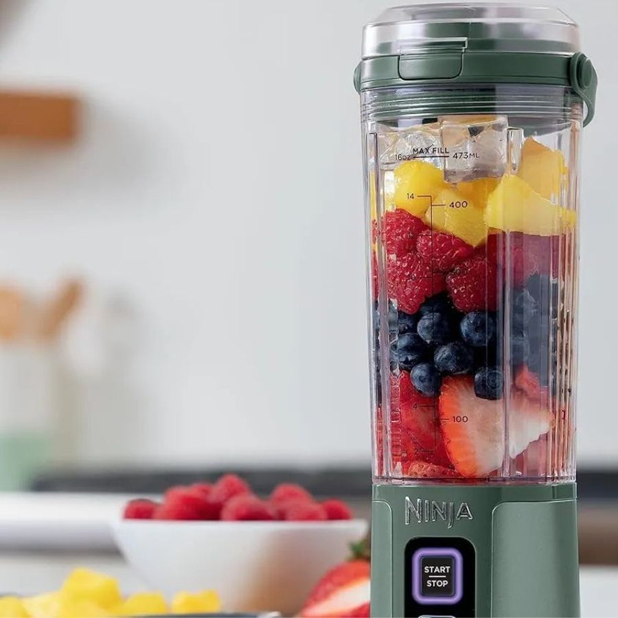 Ninja Blast in pale green blending a fresh fruit smoothie