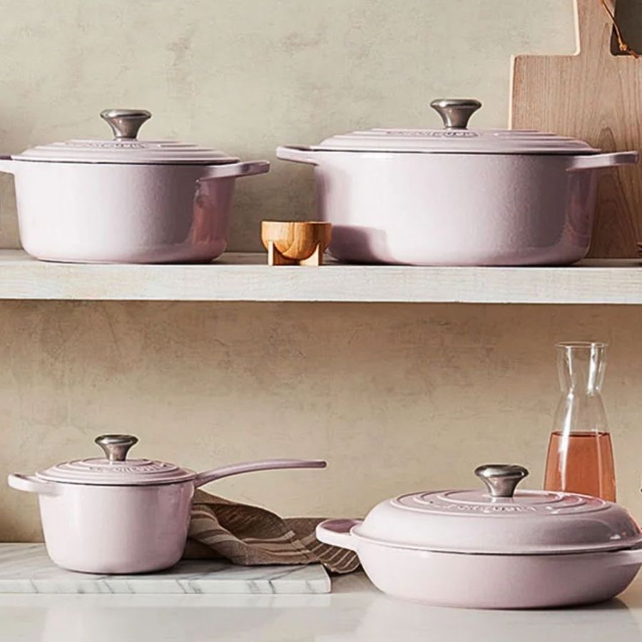The complete Le Creuset Shallot set of pans and lids across a countertop and shelf.