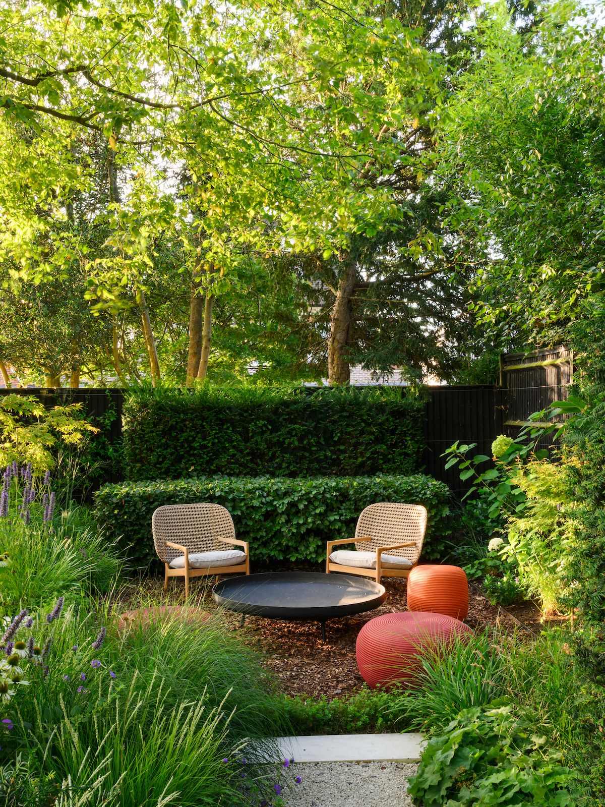 fire pit area with armchairs and lush planting