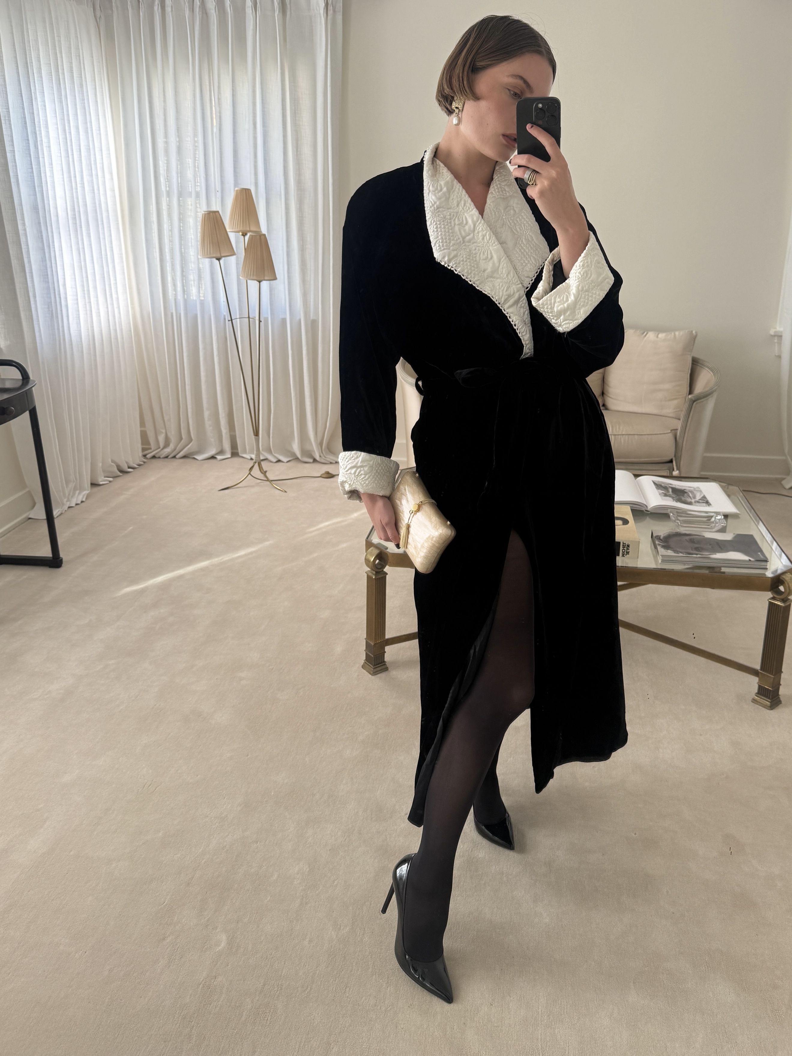 Mirror selfie of Christie Tyler wearing a vintage robe