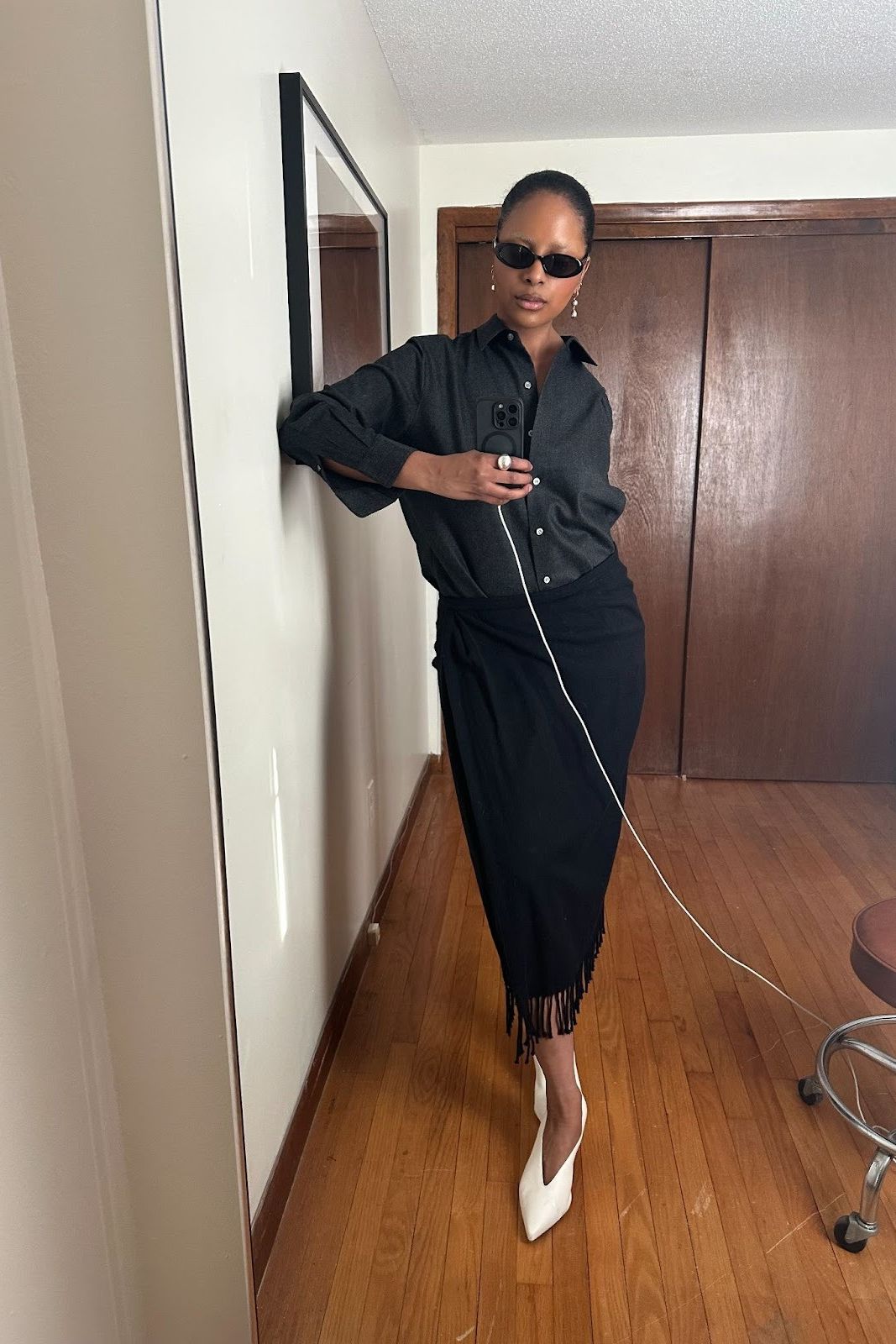 Maya Moore wearing a black top, a black skirt, and white shoes