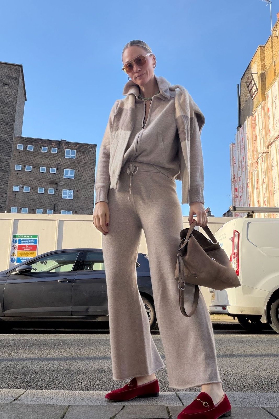 Brooke Ely Danielson wearing a cozy knit set with scarlet loafers on the street