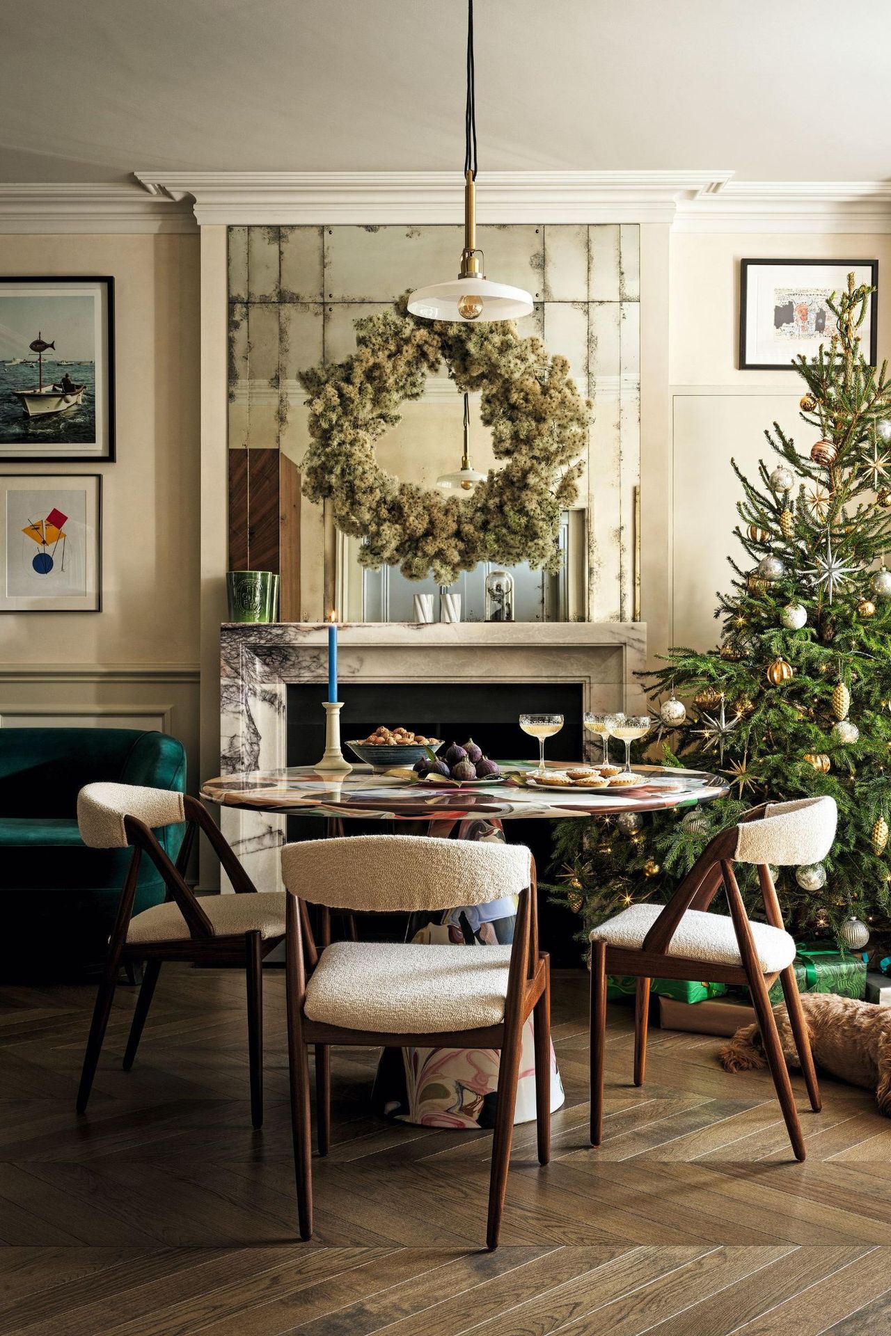 dining table with round marble table and wooden chairs and christmas tee and wreath