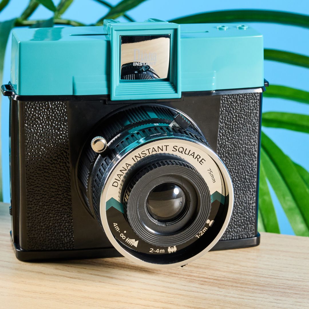 An Instax Square camera with interchangeable lenses and
