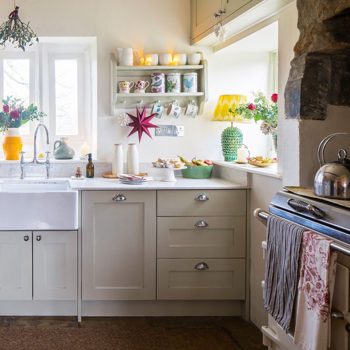 A cream painted farmhouse style kitchen with belfast sink