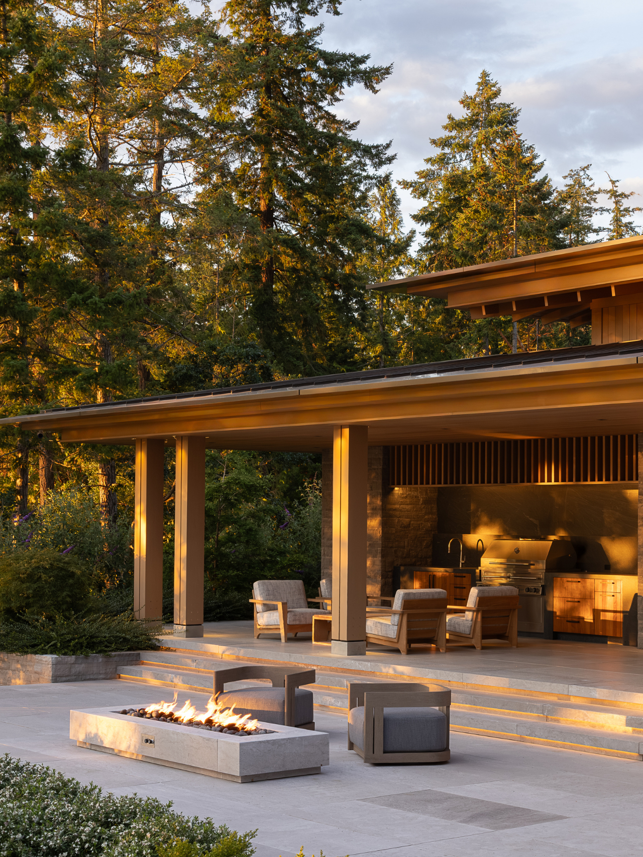 beautiful outdoor space set amongst the forest with fire pits and outdoor seating