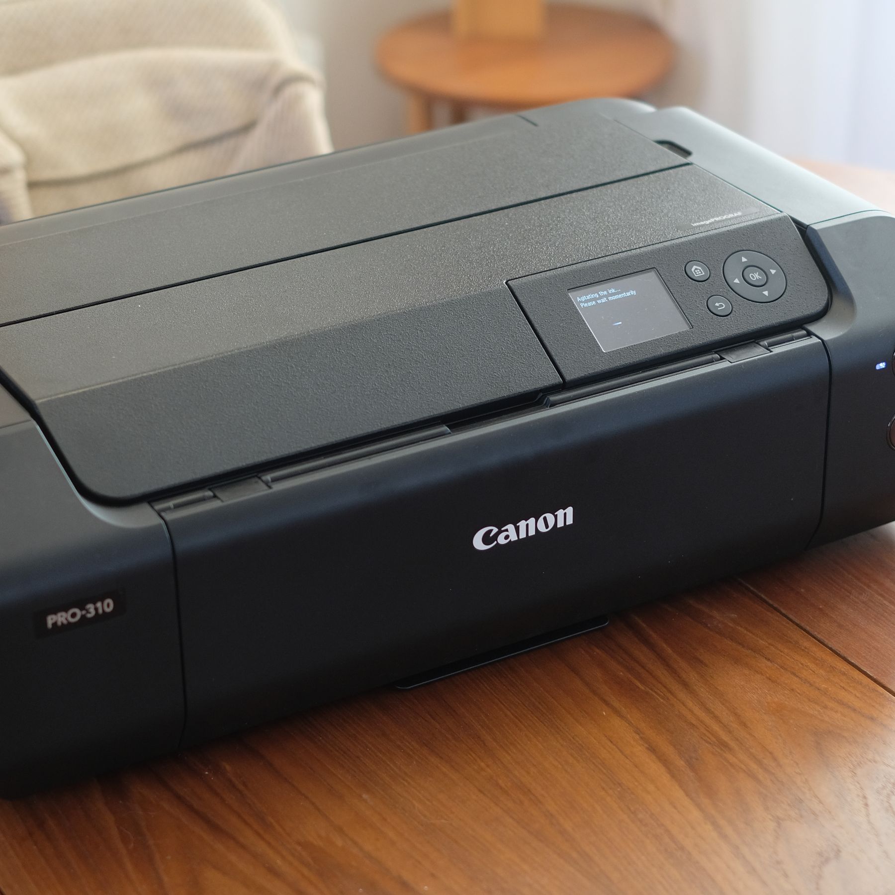 A photograph of the Canon imagePROGRAF PRO-310 printer folded on a table
