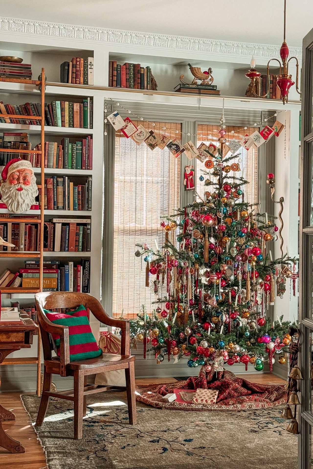 A Christmas tree decorated with vintage ornaments, dried orange slices, and colorful Mid-Century baubles