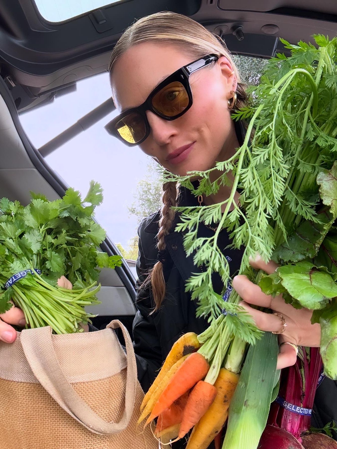 Brooke Ely Danielson holding a carrot and wearing sunglasses