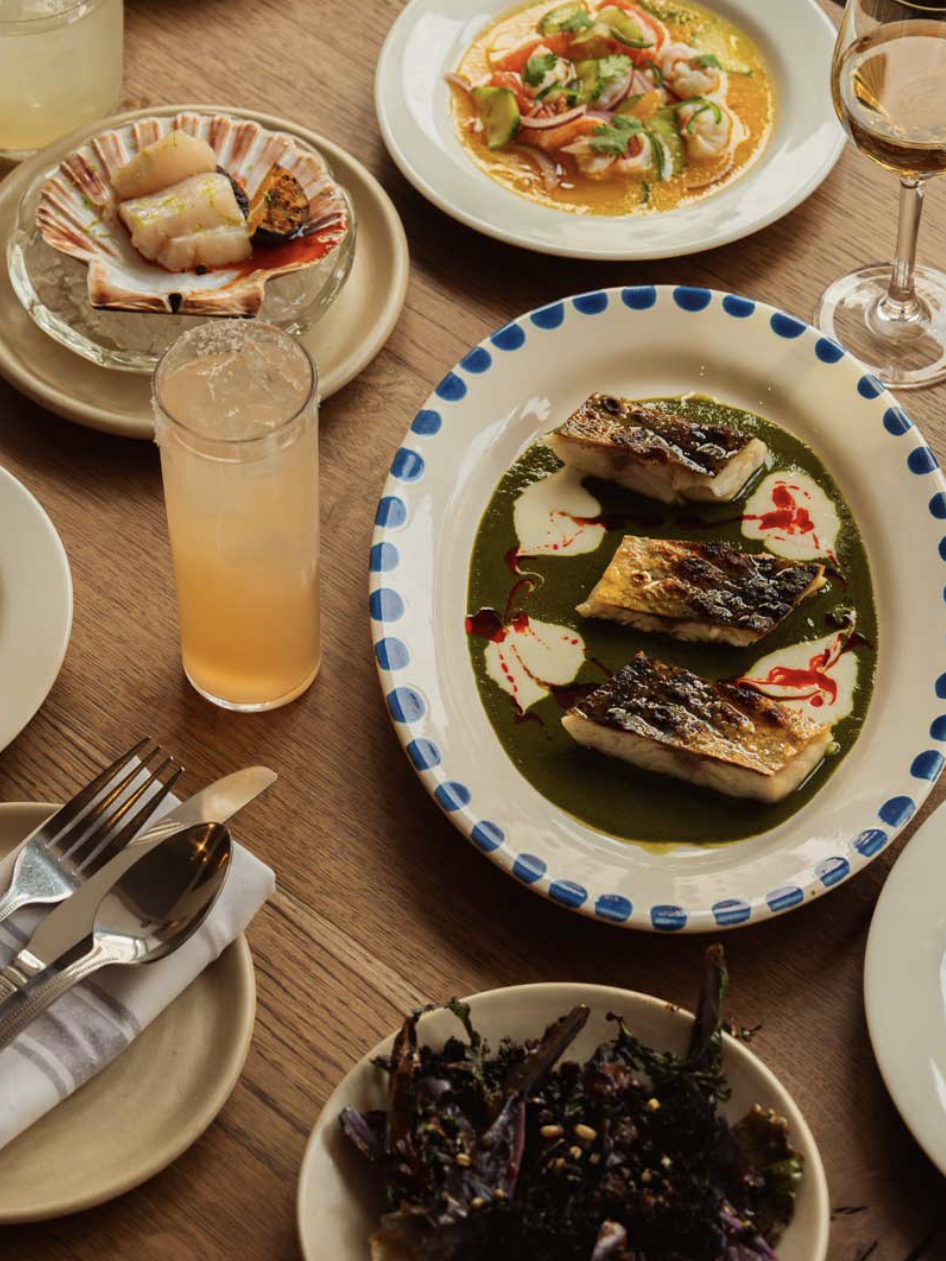 an image of four dishes on a table at Cometa with a cocktail and a glass of wine