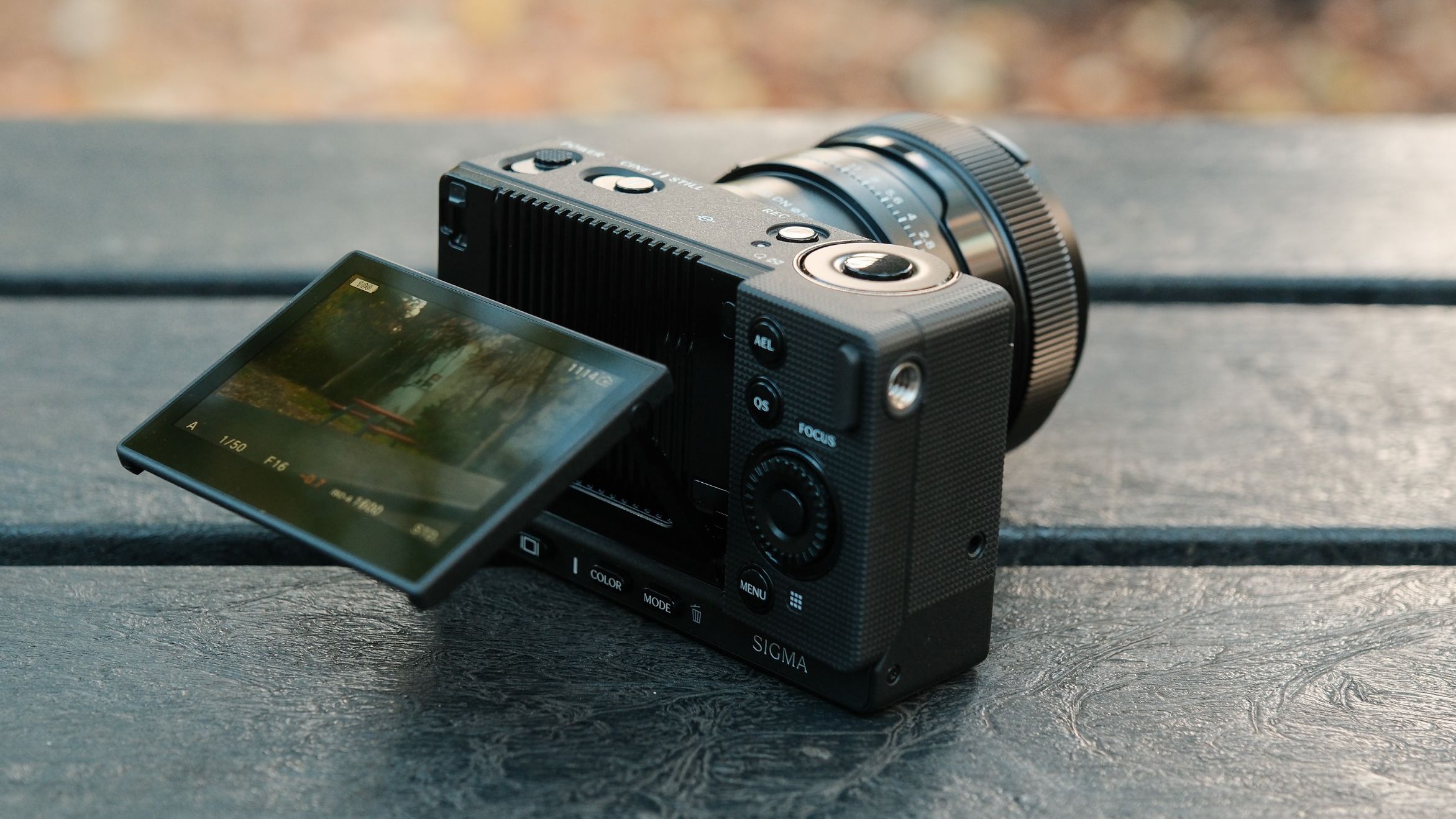 Rear three-quarter view of the Sigma FP2 with its articulated screen tilted out and a lens attached.