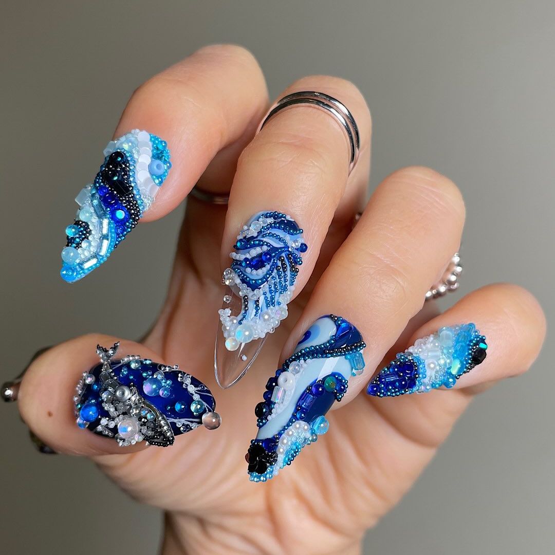 blue manicure with lots of texture and details