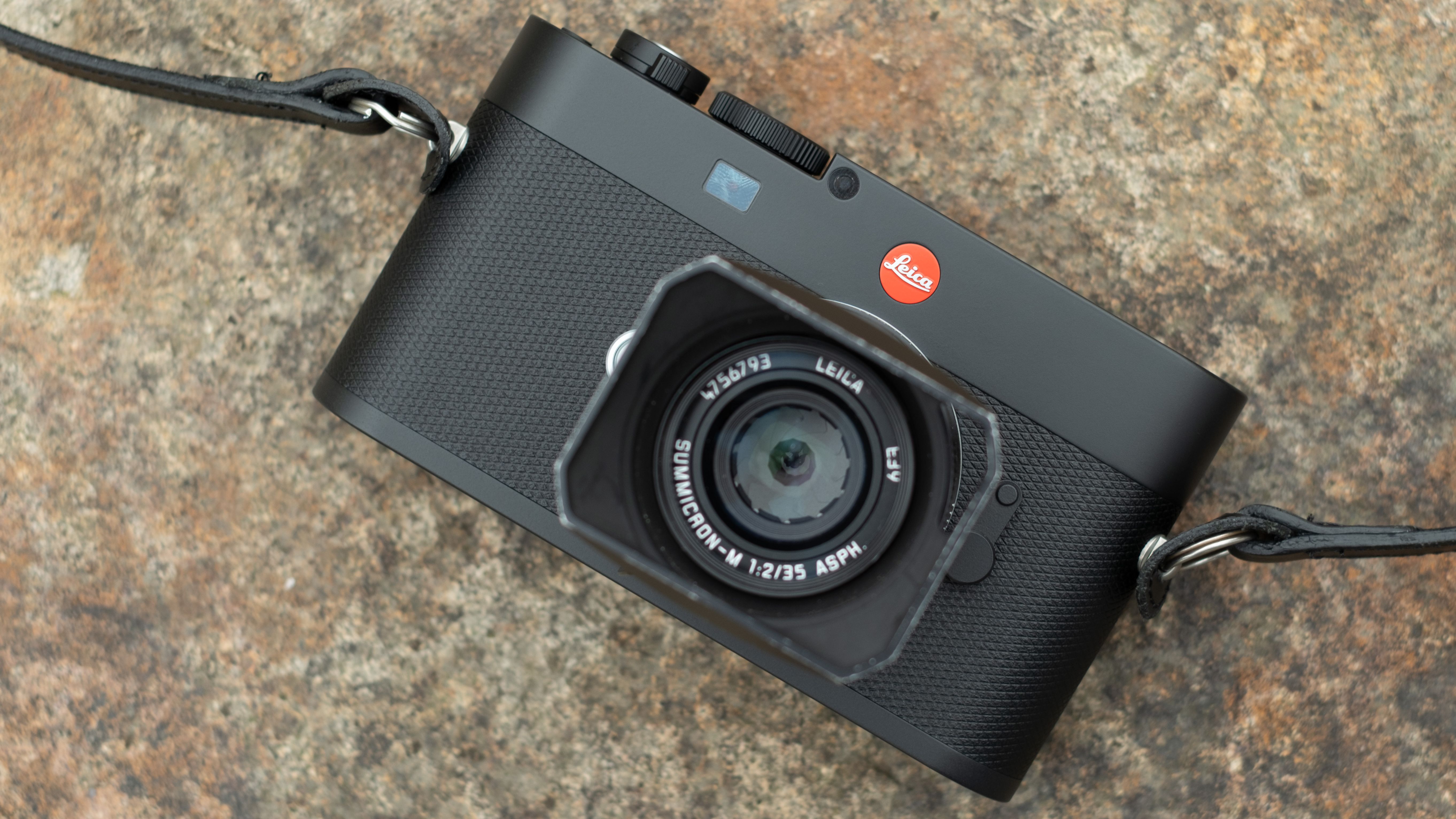 Leica M EV1 digital camera with lens attached on a stone surface