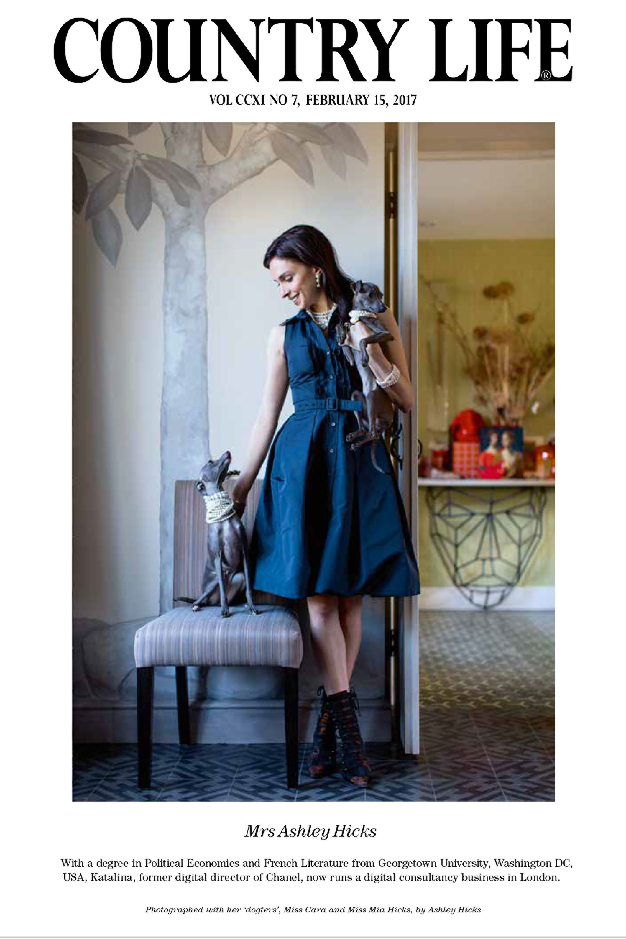 Frontispiece page of a woman in a navy shirt dress posing with two Italian greyhounds
