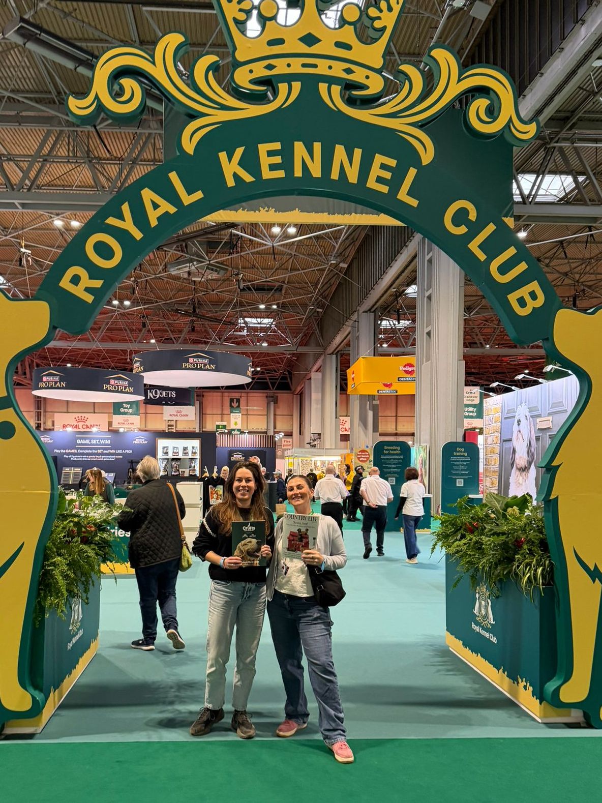 Agnes Stamp and Flo Allen posing under a giant arch