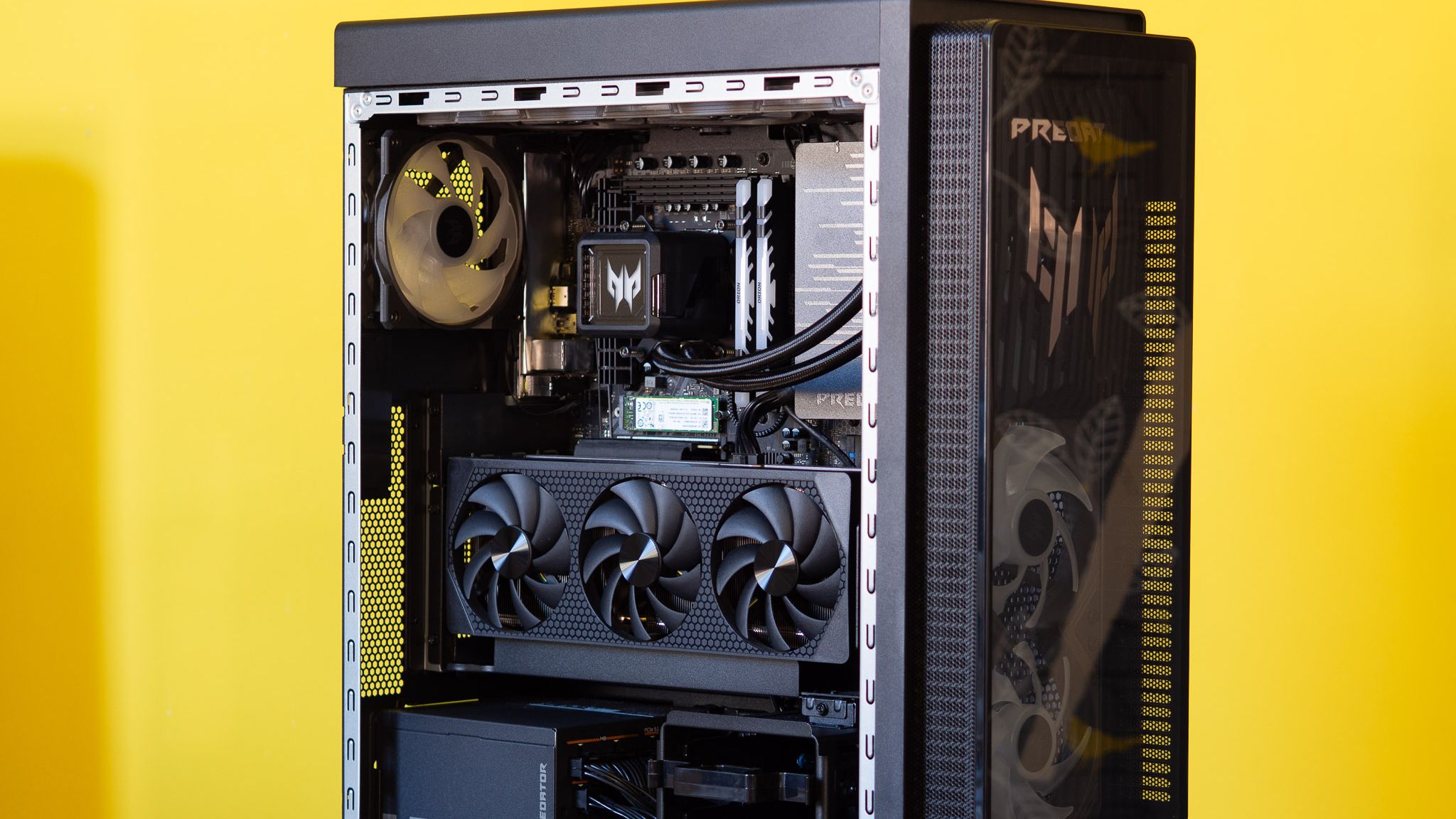 Acer Predator Orion 7000 gaming desktop PC on a wooden desk and yellow background