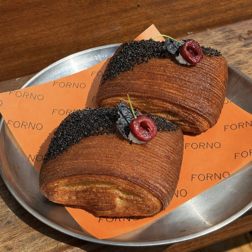 an image of a special black sesame and italian cherry pain suisse on offer at Forno created by guest chef Minseok