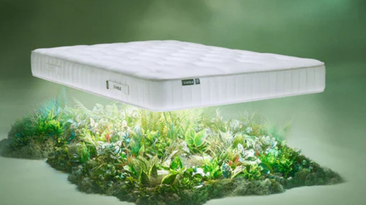 Simba Source Mattress hovering above a bed of botanicals