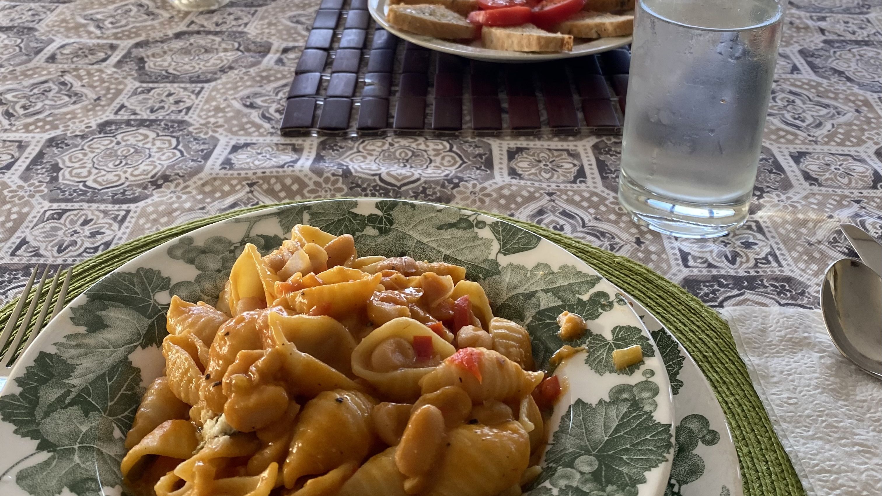 A bowl of pasta e fagioli on a table.