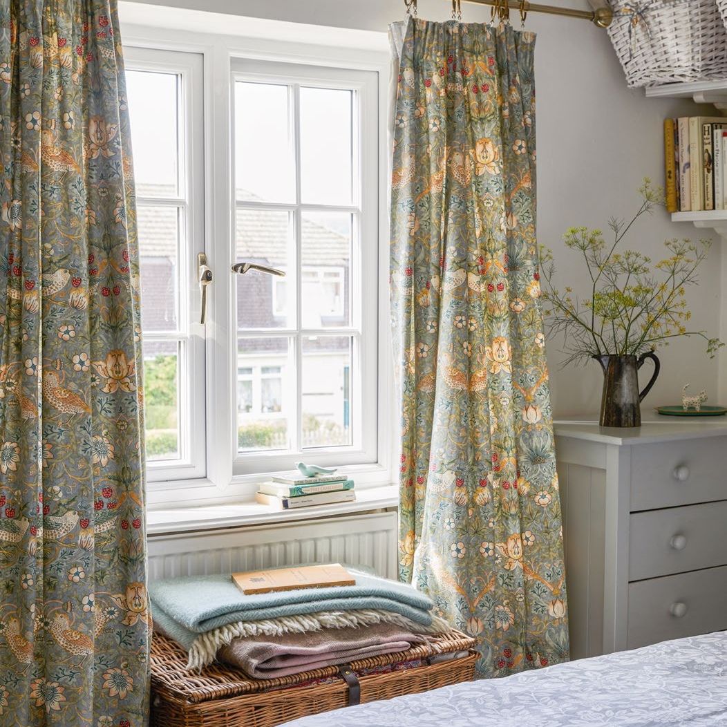 cottage bedroom with William Morris print curtains