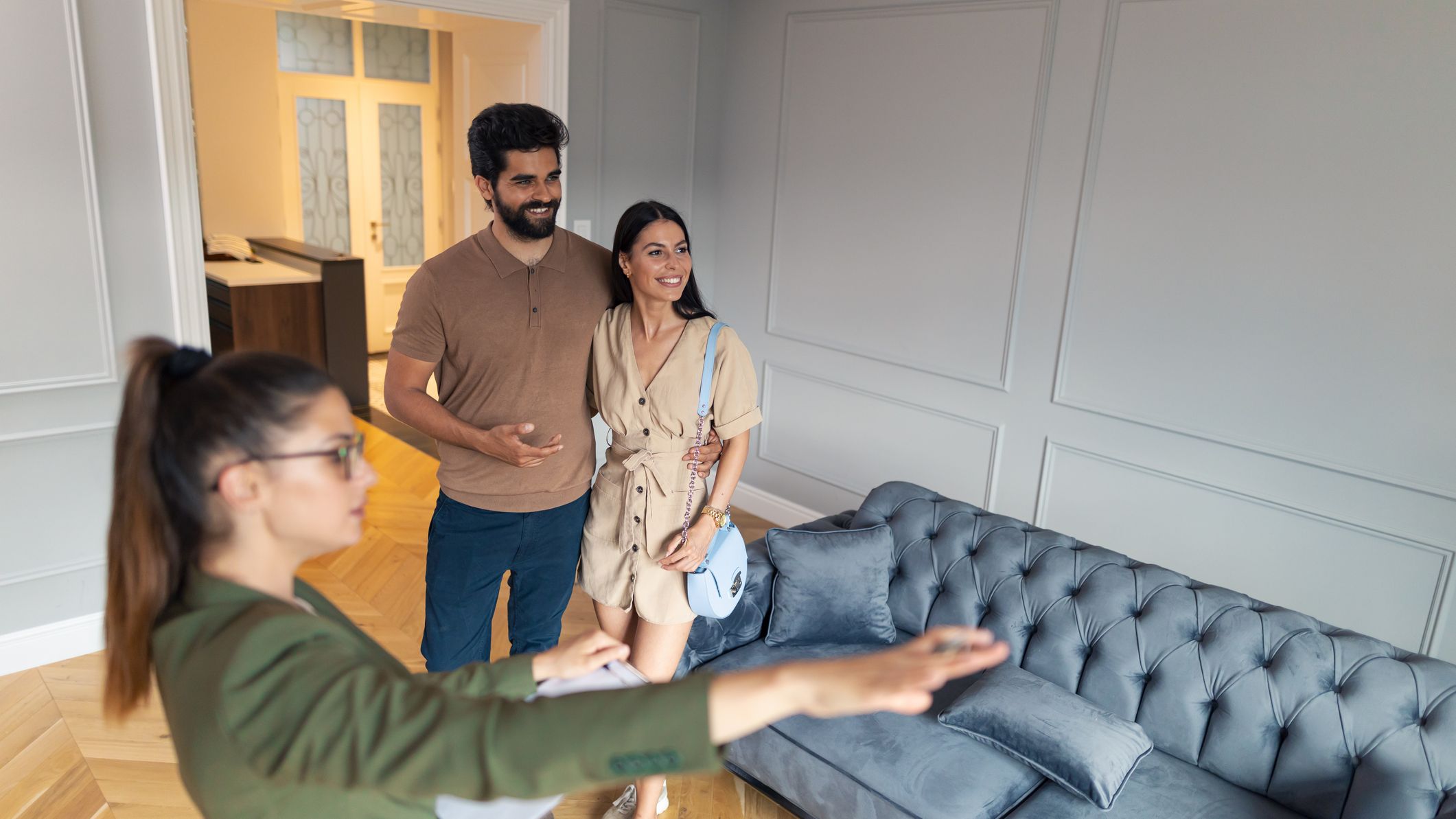 Real estate agent shows a young married couple a new apartment.