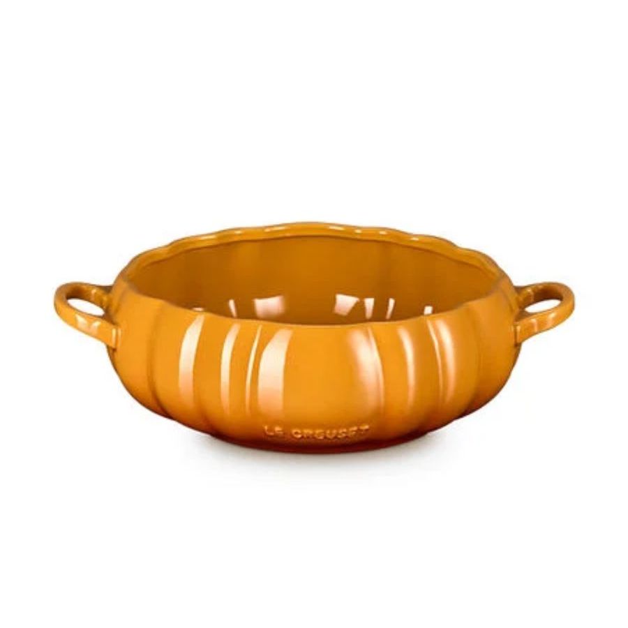 An orange Le Creuset pumpkin shaped serving dish