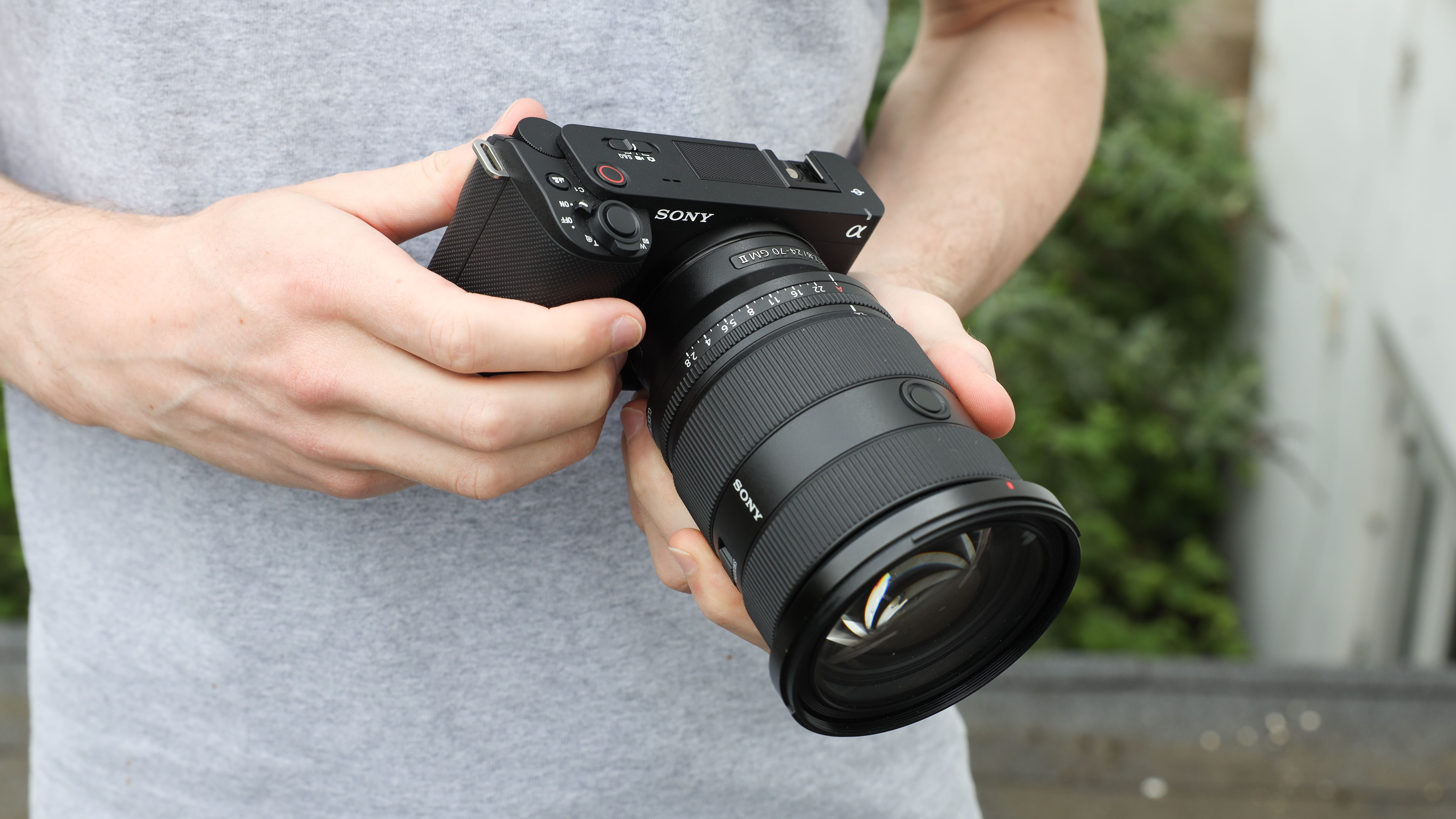 Sony ZV-E1 digital camera being held in two hands by reviewer