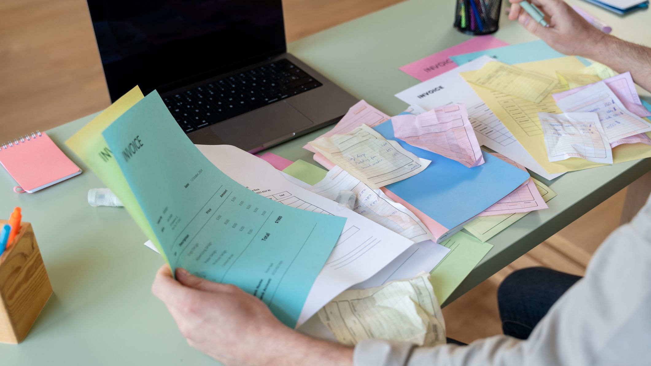 A person sorting their paperwork at a desk