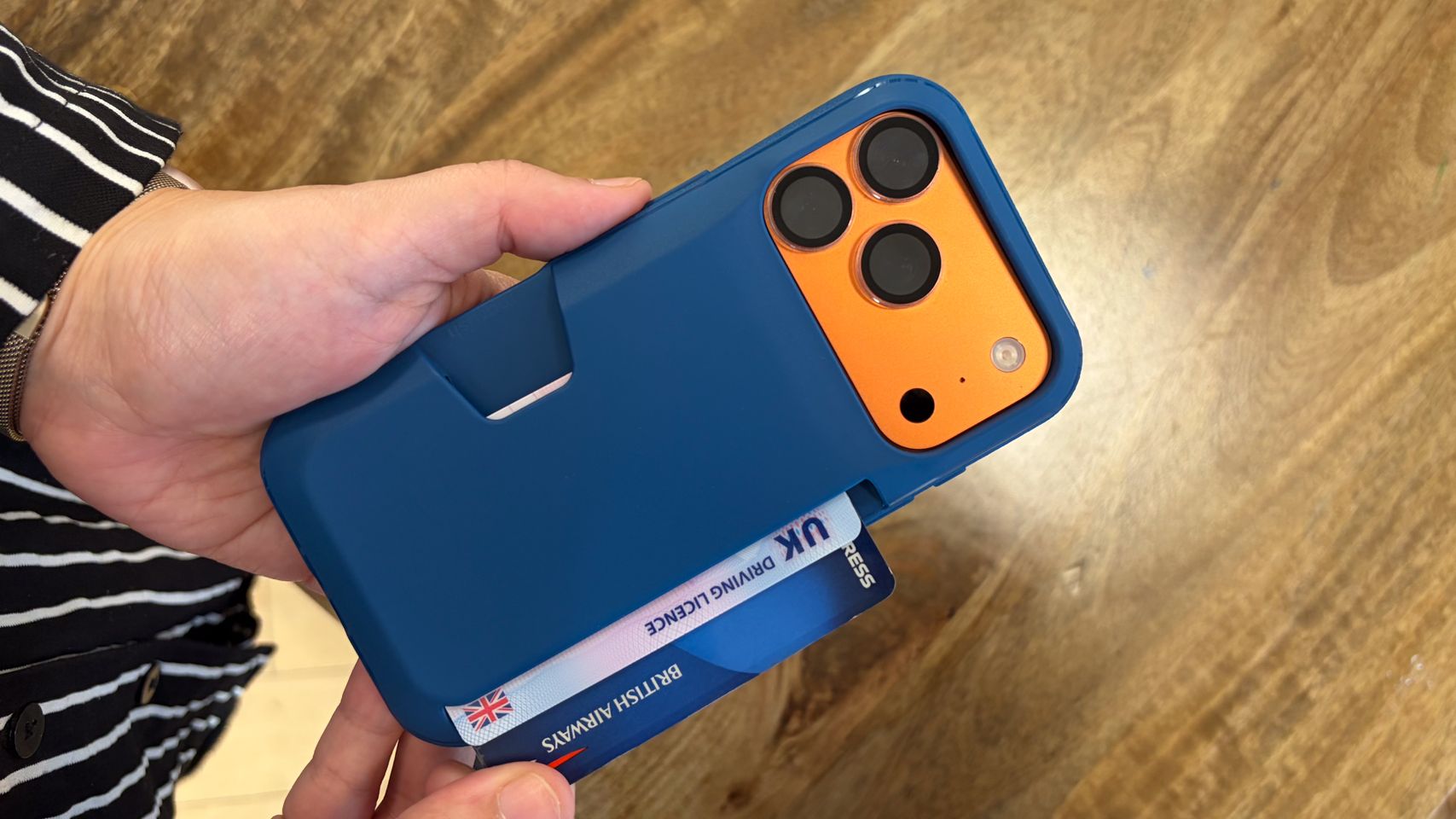 Person using an iPhone in a Smartish Wallet Slayer Vol.1 iPhone 18 Pro case