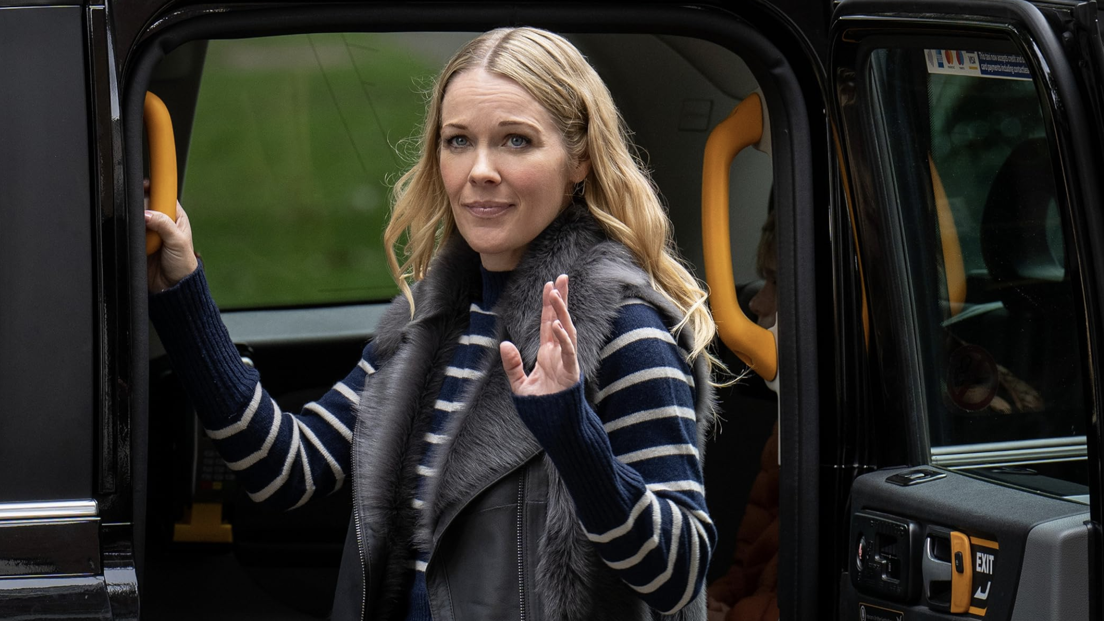 a production image from Ted Lasso S3 showing Michelle Lasso waving goodbye as she gets into a Black Cab
