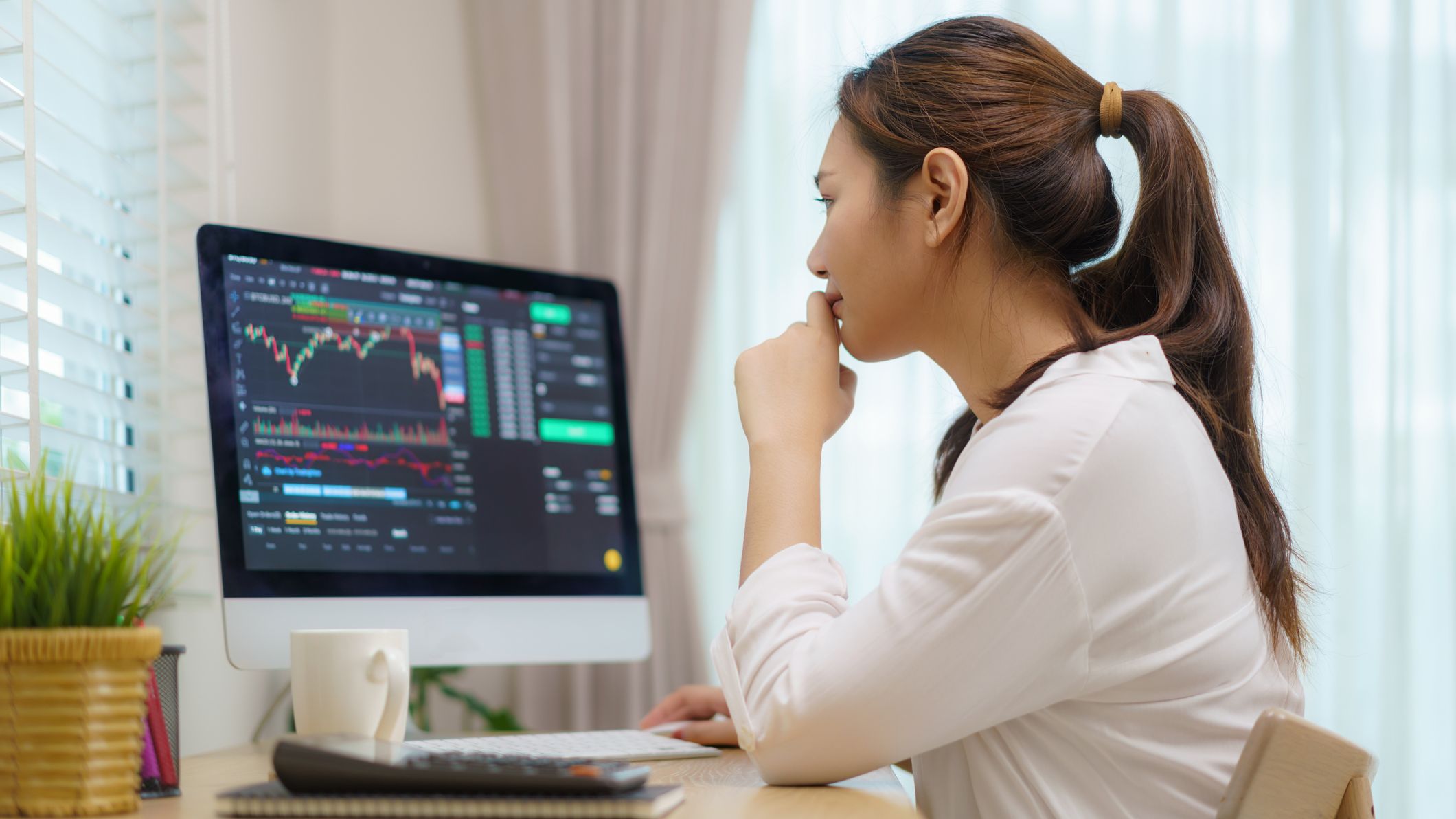 a woman watching her investments on a computer