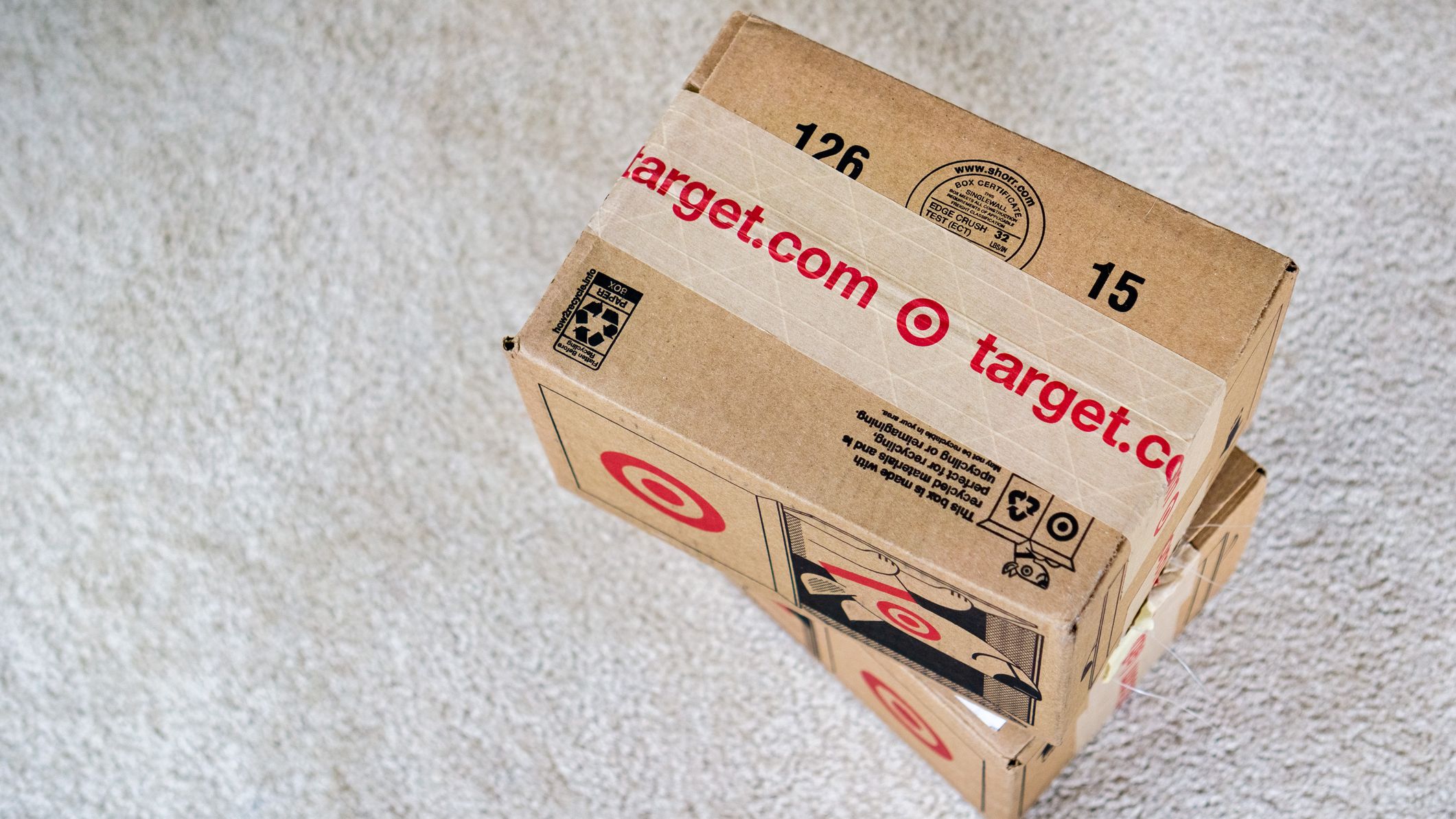 Target packages stacked on top of white carpet.