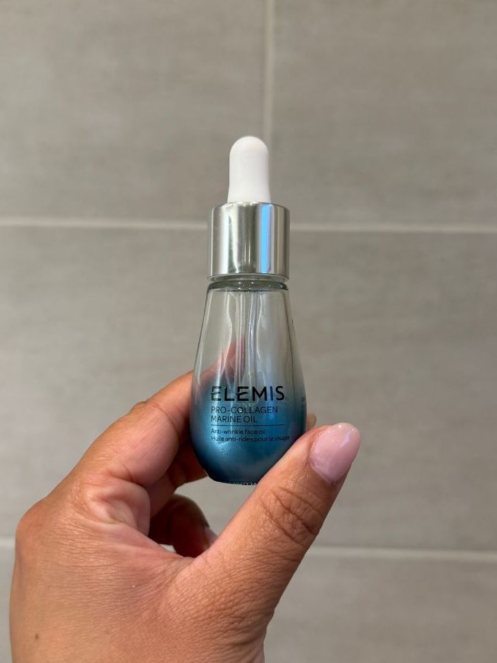 Aleesha holding empty Elemis Pro-Collagen Marine Oil