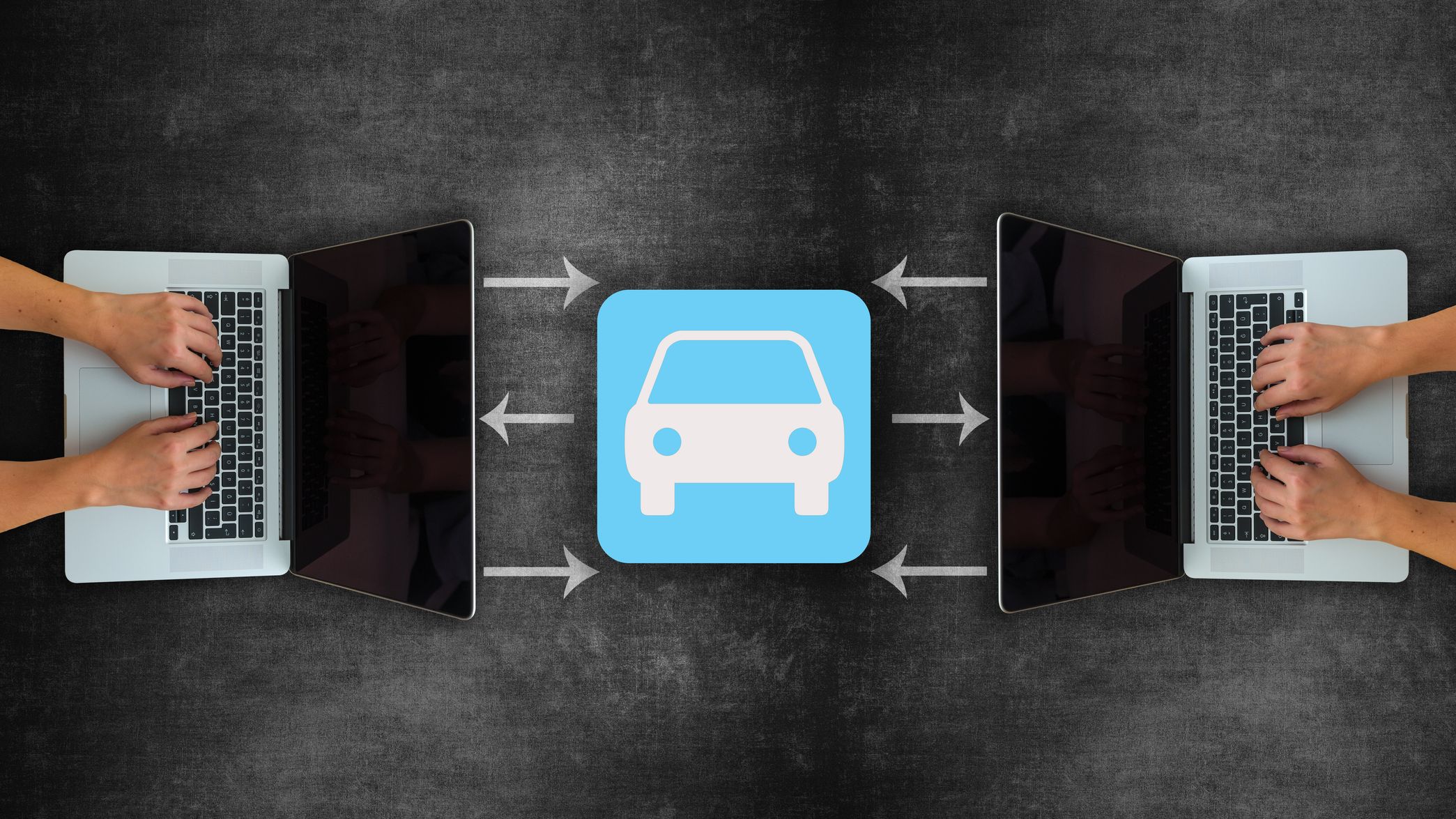 Two people using laptops with a car icon in the center