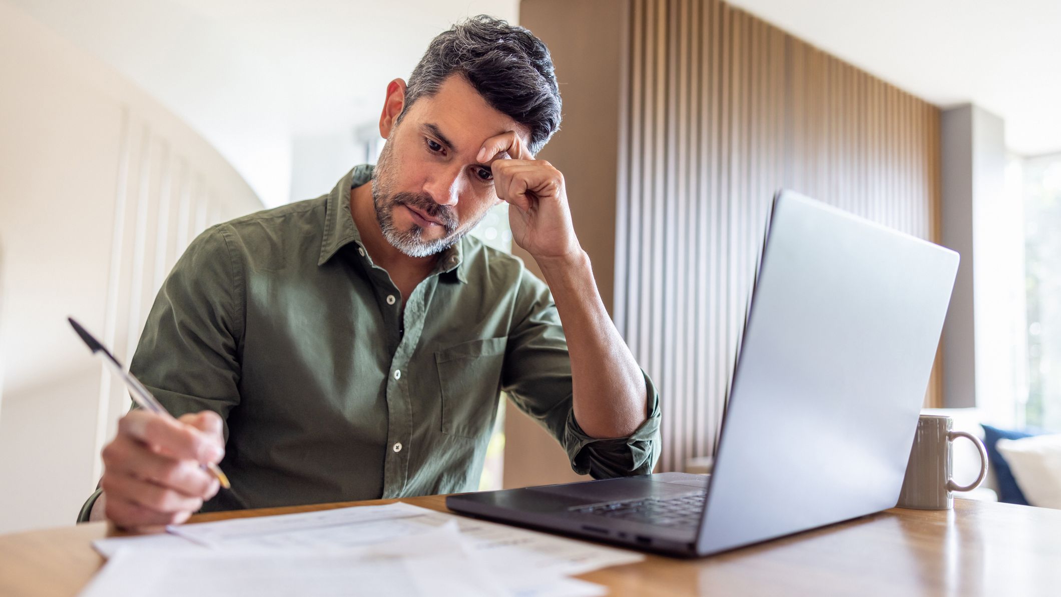 Man working at home and looking worried