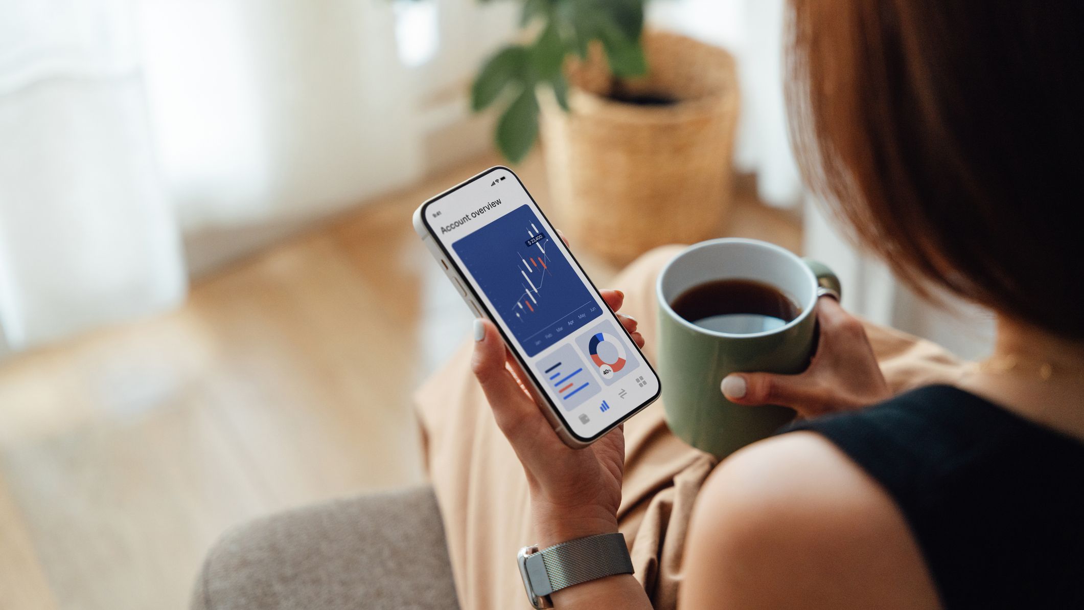 Young woman managing bank account with mobile banking app on smartphone