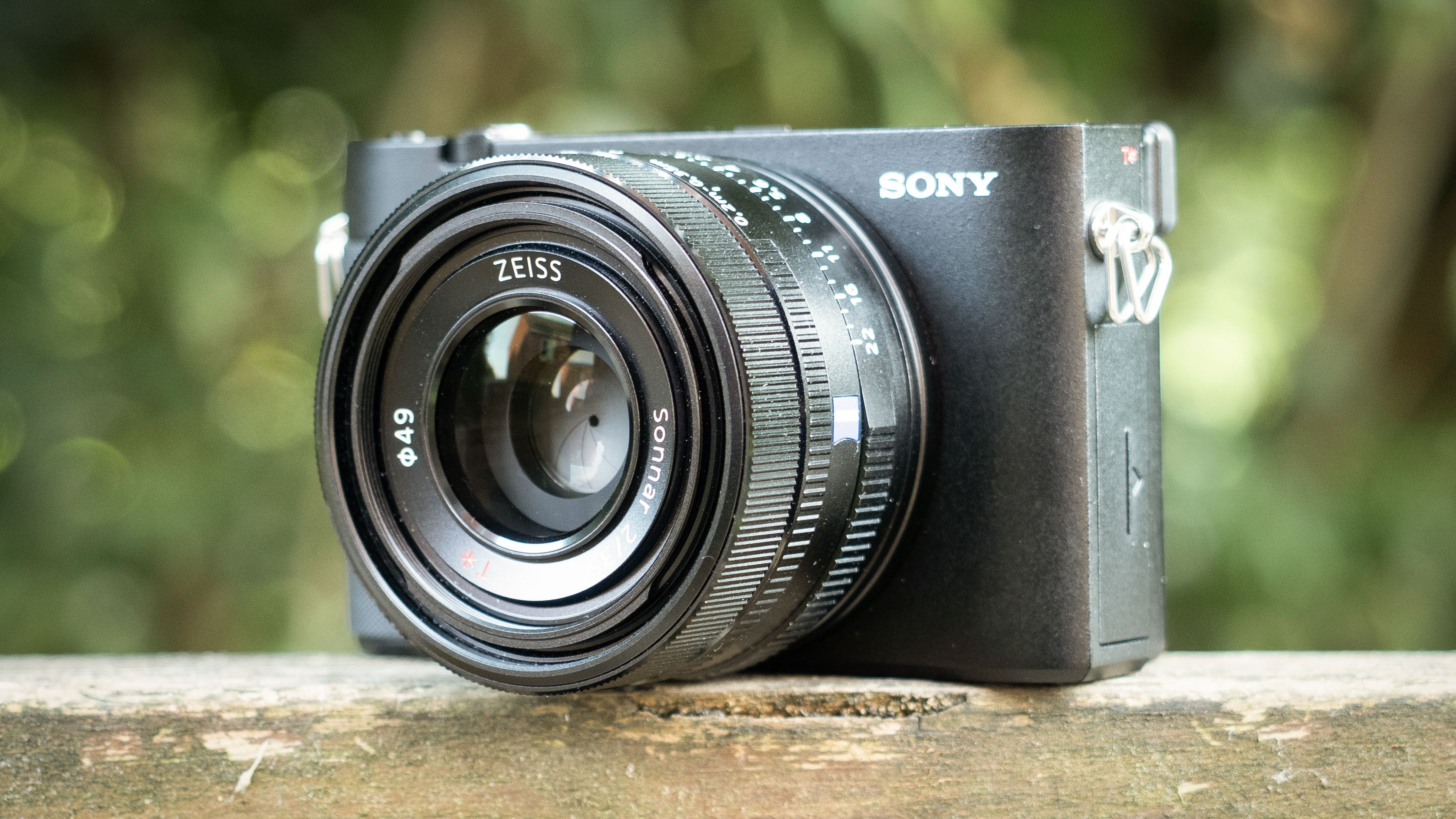 Sony RX1R III on a wooden surface in a woodland environment