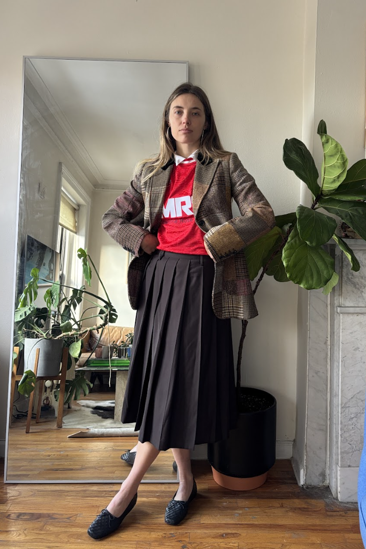 Aemilia Madden wearing a soccer jersey, a skirt, and a blazer