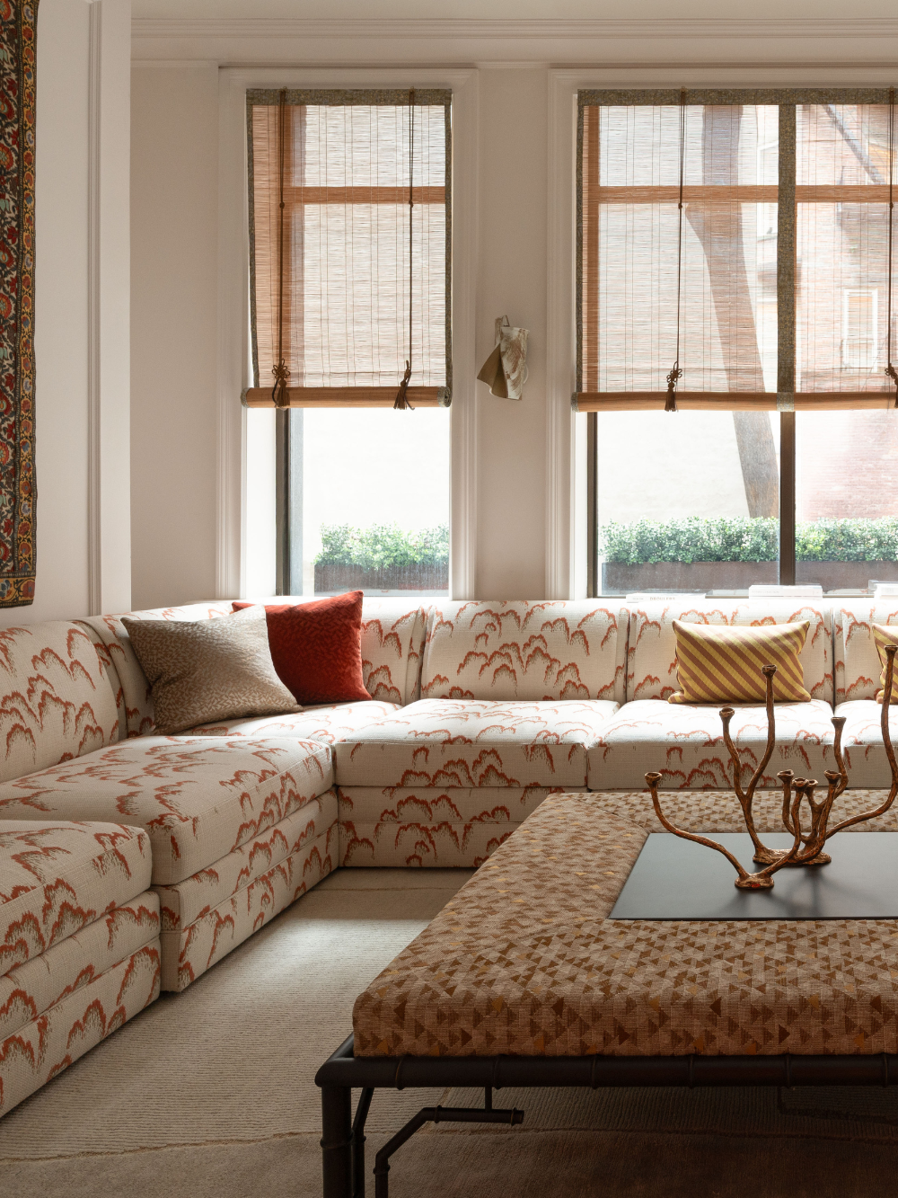 Dedar-upholstered sectional sofa and coffee table pictured in the living room of an Upper East Side townhouse