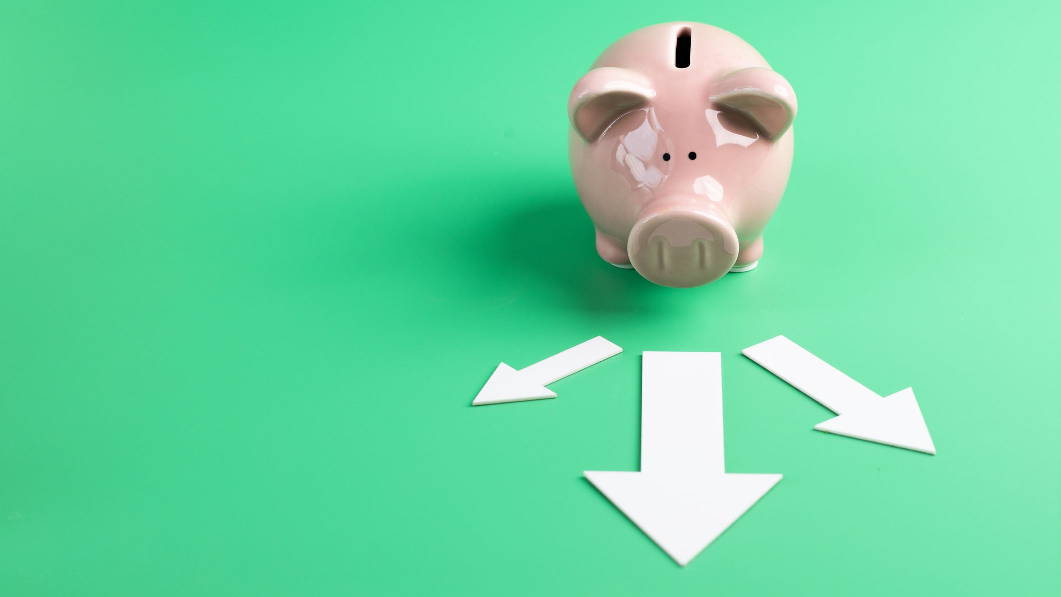 a piggy bank faces arrows heading to the front left and right away from it