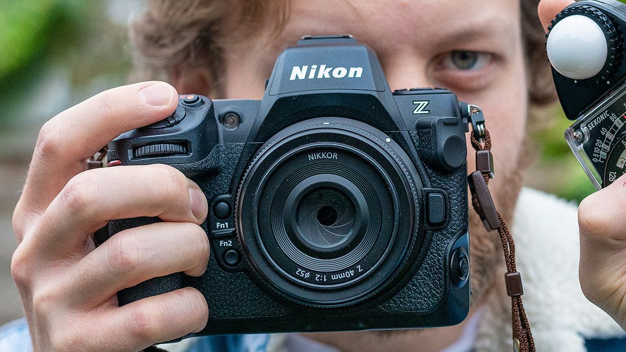 Sekonic Studio Deluxe III L-398A being held by man holding Nikon Z8