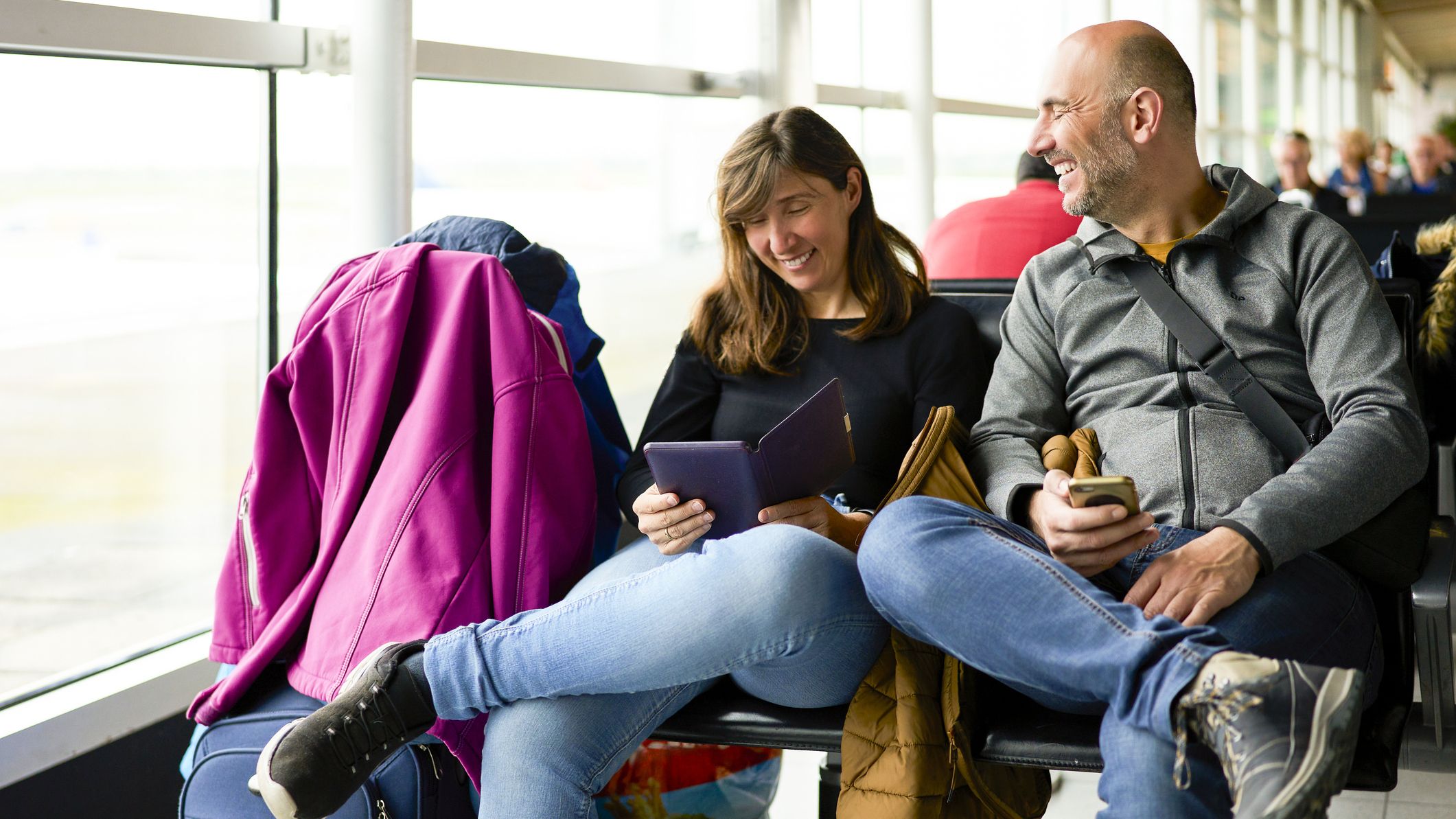 Couple waiting for their flight at the airport terminal