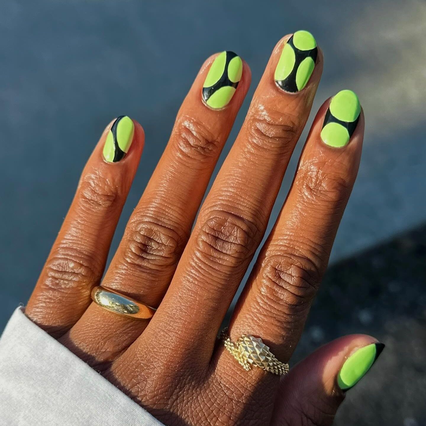 green and black polka dot manicure